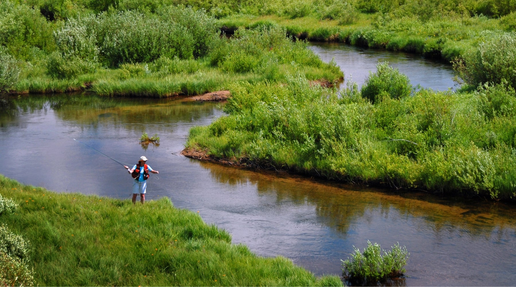 angler fly fishes on a trout stream in Montana