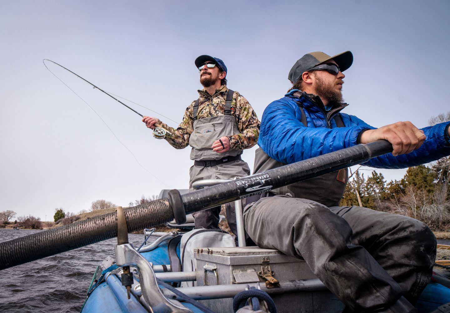 Two anglers fishing from boat in Montana