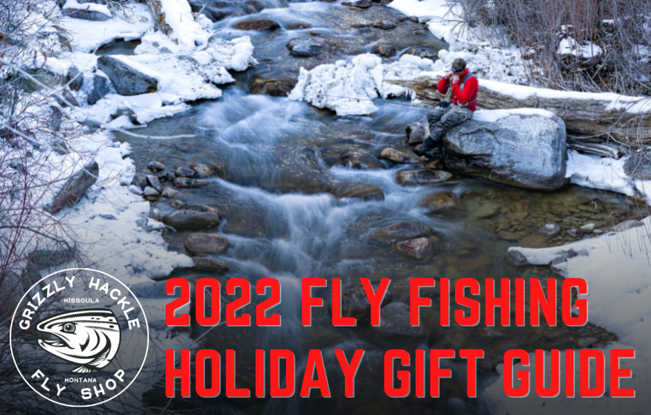 A fly fisherman sits on a cold snowy stream during the holidays